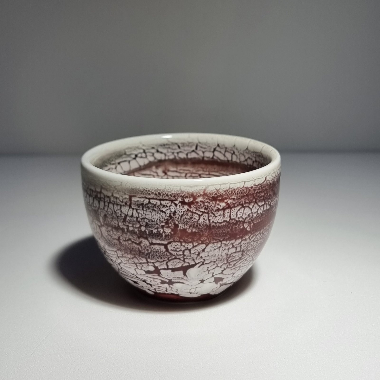 Handmade crackle glaze ceramic matcha bowl in burgundy and cream