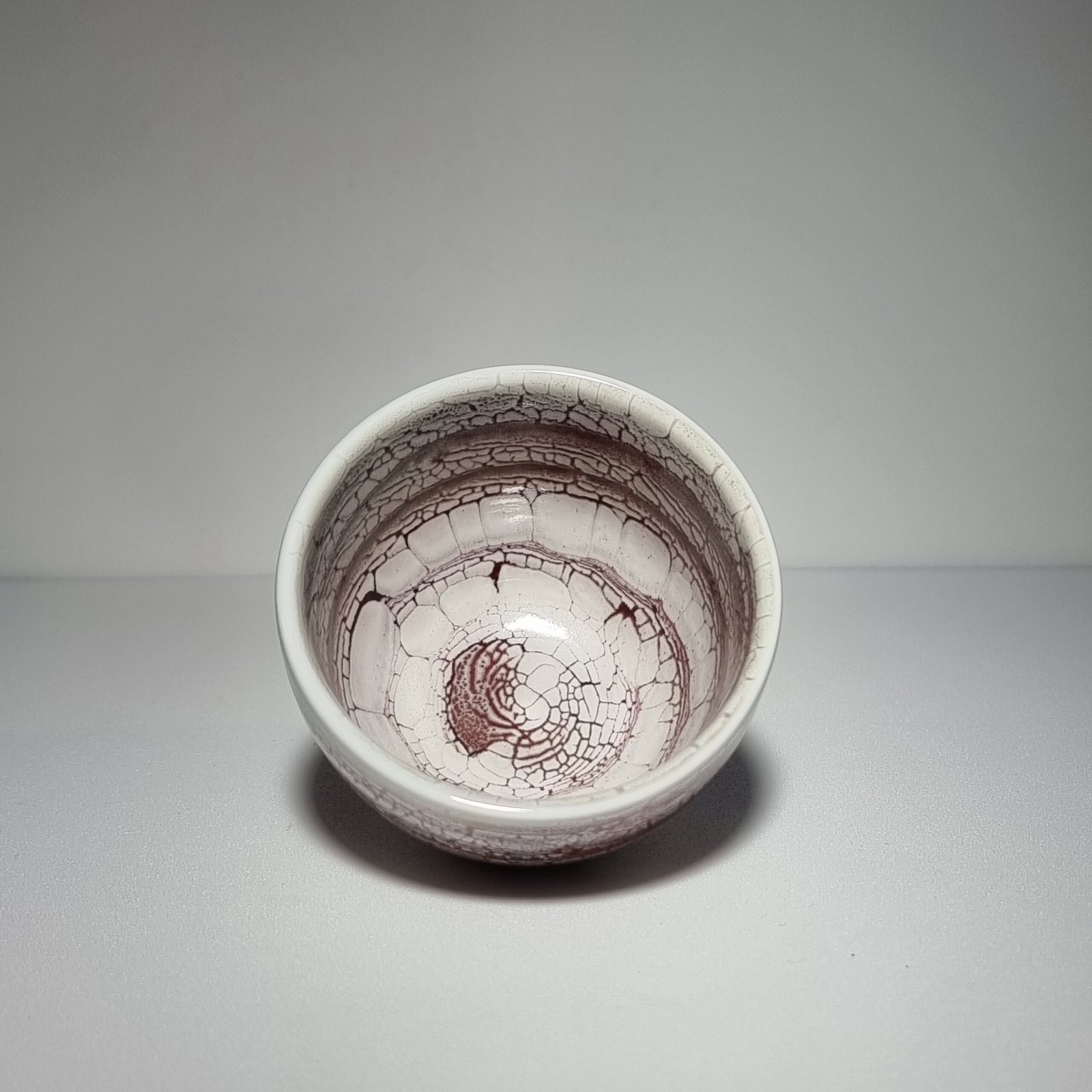 Interior view of handmade crackle glaze teacup
